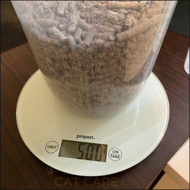 A photo showing the amount of Scrunch and Sticks recycled paper cat litter that fills a measuring container (C) Simply Cat Care